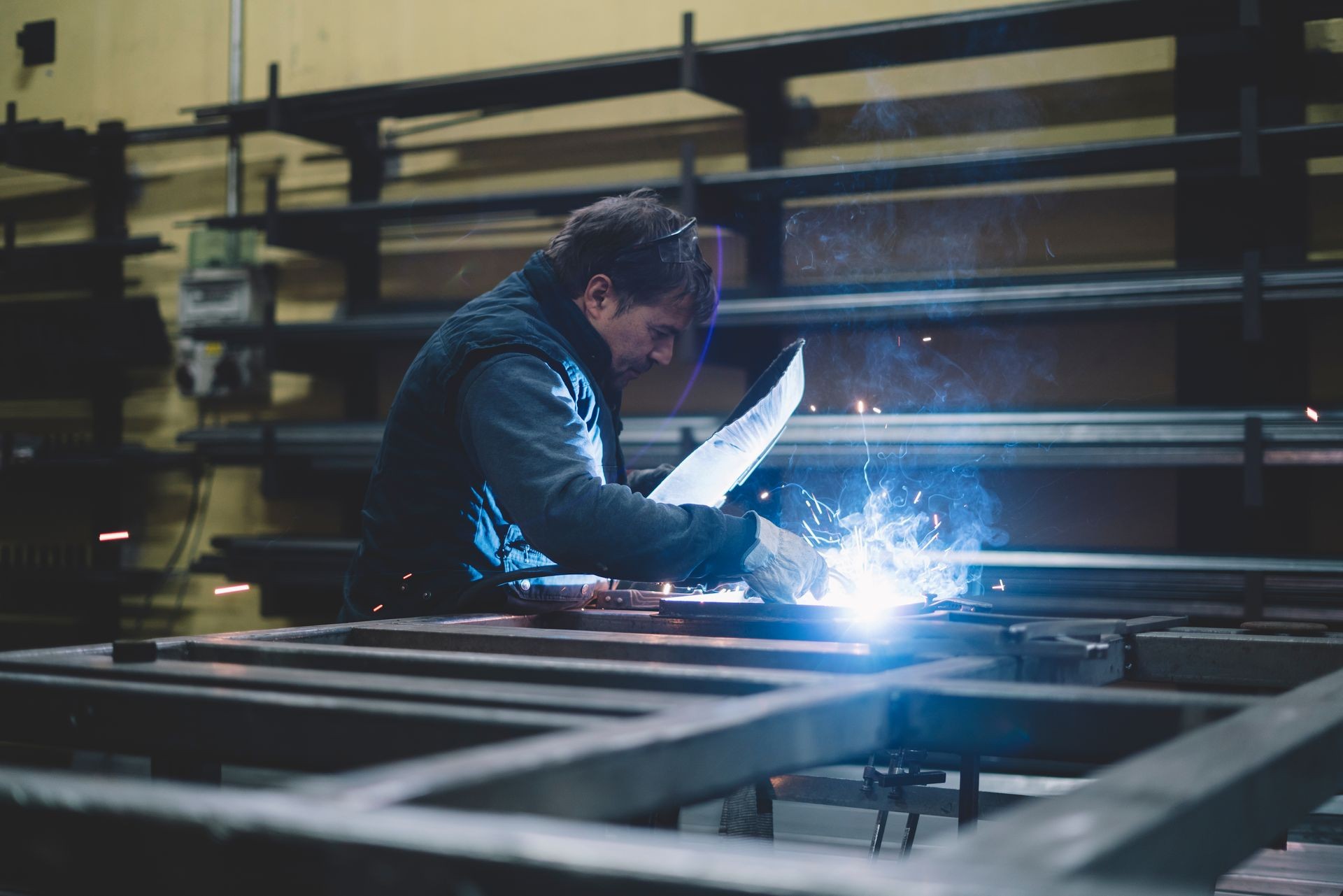Man working in welding workshop.